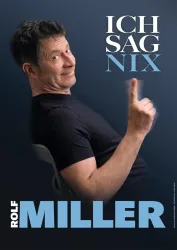 Ein lächelnder Mann in einem schwarzen T-Shirt sitzt auf einem Stuhl und zeigt mit dem Finger nach oben. Der Text "ICH SAG NIX" und "ROLF MILLER" ist prominent im Bild zu sehen.