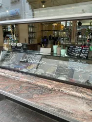 Ein gemütliches Café mit einer einladenden Theke und dekorativen Menüs. Die Inneneinrichtung ist modern und ansprechend.