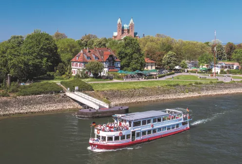Ein Personenschiff auf dem Rhein an der Promenade der Stadt Speyer